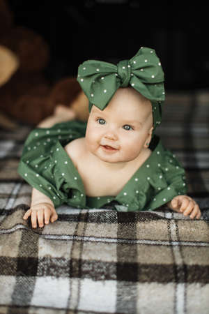 Happy caucasian little baby girl lying inside car trunk looking at camera and smiling. Advertisement banner with cute child posing indoor. Panorama with copy space for your text.の写真素材