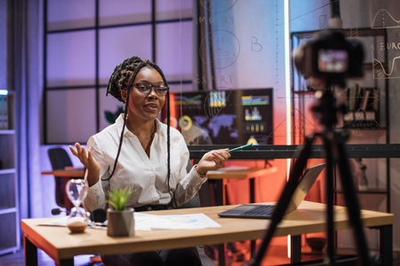 Portrait of attractive confident experienced smart female african american office manager in headset...