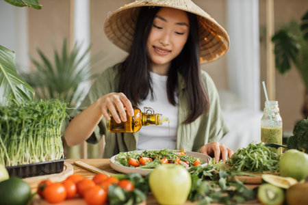 Young attractive asian woman in traditional conical hat sitting at table in stylish light tropical...