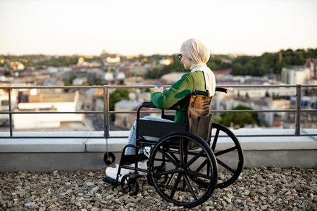 Rear view of arabian woman in hijab scanning information on smartphone screen against city scenery....