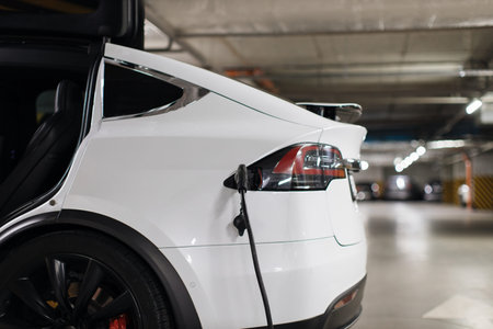 E-car being refilled with energy at underground parking lot