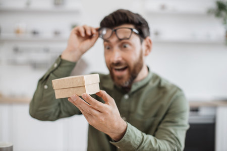 Surprised blogger opening cardboard parcel box onlineの写真素材