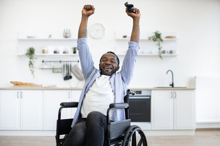 Young adult with disability holding hands with joypad high in airの写真素材