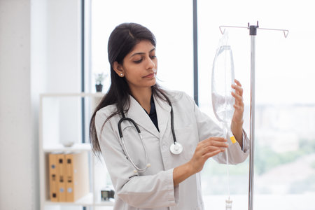 Female hospital worker preparing drop counter at officeの写真素材