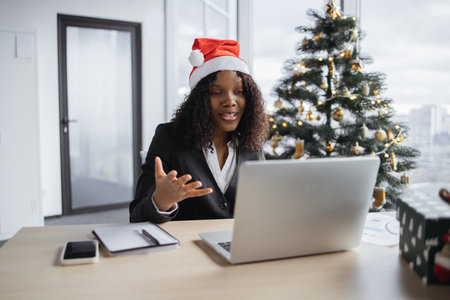 African businesswoman talking to client over video call.の写真素材