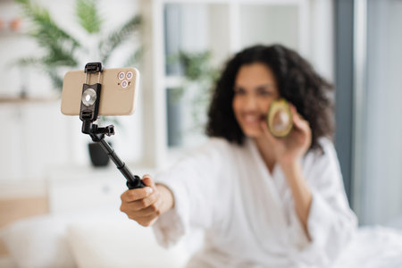 Focus on phone of young multinational woman social media influencer.