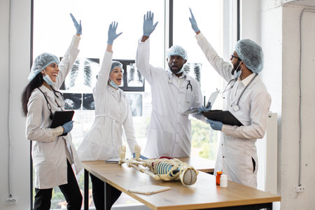 Group of medics celebrating success by raising their hands.の写真素材
