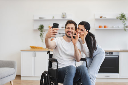 Young family with disability receiving online video call.の写真素材