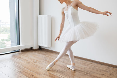 Cropped view of lags of beautiful graceful ballerina in white swan dress.の写真素材