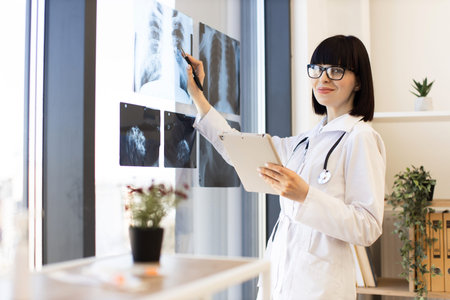 Doctor examining x-rays in a bright medical office