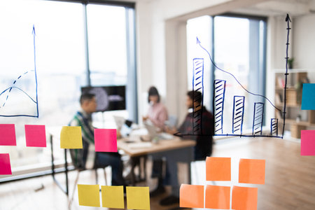 Business meeting with data analysis on glass boardの写真素材