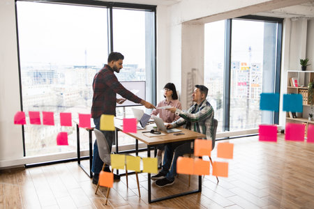Team brainstorming session with sticky notes in modern office