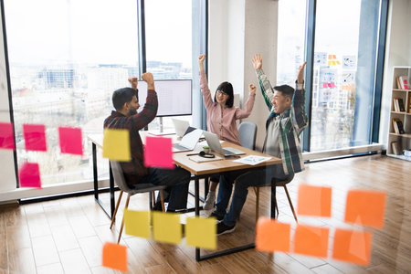 Successful business team celebrating in modern officeの写真素材