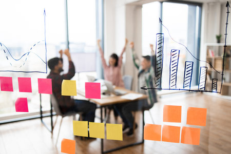 Successful business meeting with charts and sticky notesの写真素材