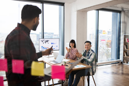 Team giving presentation in modern office environmentの写真素材