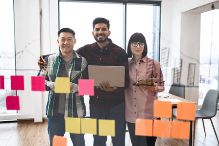 Young professionals brainstorming with sticky notes in office