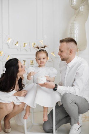 Family celebrates childs birthday with joy and loveの写真素材