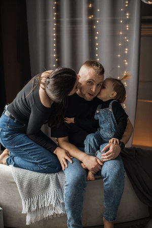 Happy family enjoying cozy moments at home togetherの写真素材