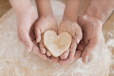 Caucasian family preparing cookies together showcasing bonding, collaboration, and wholesome indoors activity.の写真素材