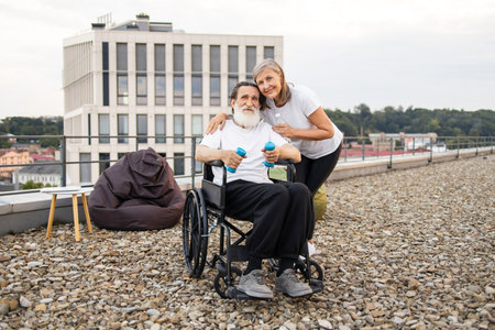 Elderly couple spending quality time exercising outdoors on urban rooftop embracing healthy lifestyleの写真素材
