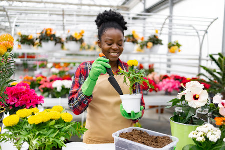 A smiling florist carefully replants flowers in a vibrant shop, showcasing a passion for gardening...