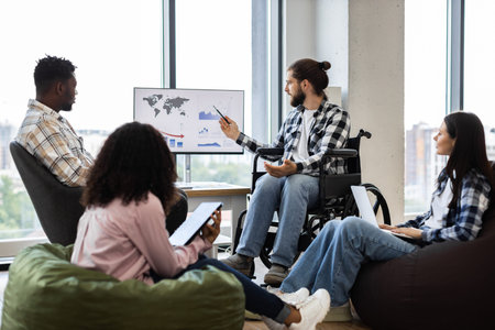 Young professionals discussing global business report on monitor in relaxed office environment....
