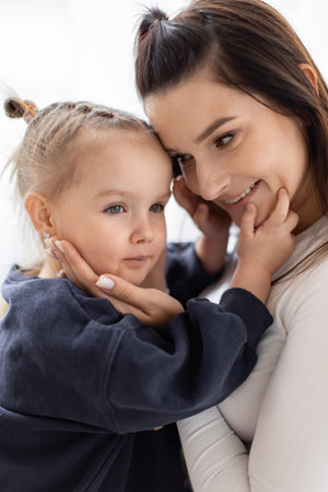 A tender moment between a mother and her young daughter, filled with love and affection.の写真素材