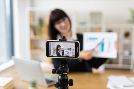 Caucasian woman recording business presentation, sharing strategies and data analysis from laptop setupの写真素材