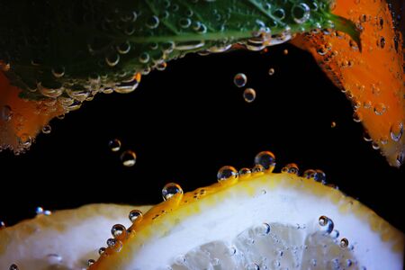 Citruses in water with air bubblesの写真素材