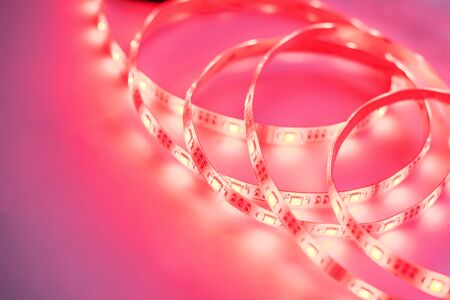 Bright neon LED strip glows coral pink. Copyspace.の写真素材