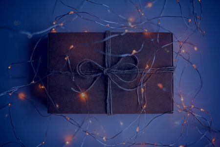Gift box of craft cardboard in a luminous garland on the white background.の写真素材