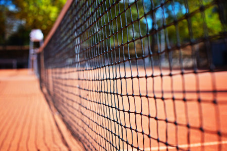 Tennis net on the tennis court at the day time. Blurred
