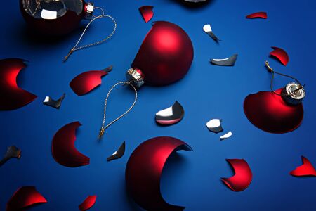 Broken red christmas balls on the classic blue background. Color of the year 2020, Classic Blue.の写真素材