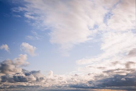 Cumulus white and gray clouds on a blue sky. Beautiful dreamy scene of air clouds on blue sky background.の写真素材