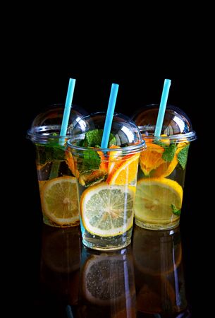 Three glasses of lemonade isolated on a black background.の写真素材