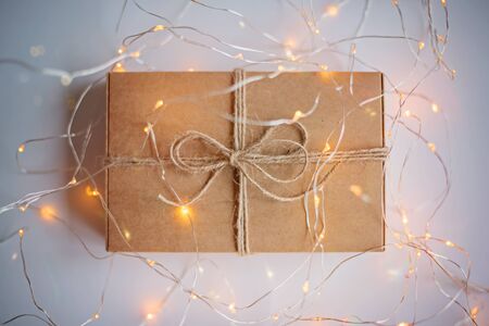 Gift box of craft cardboard in a luminous garland on the white background.の写真素材