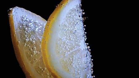 Citruse lemon in water with air bubblesの写真素材