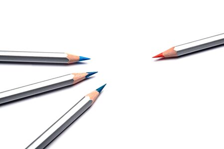 Multi colored classic blue and orange pencils on a white paper. Place for text. Copy space.の写真素材