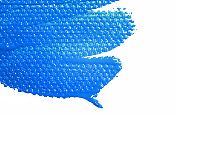 Elongated brushstroke, puddle of blue acrylic paint. Isolated. Color of the year 2020, Classic Blue.の写真素材