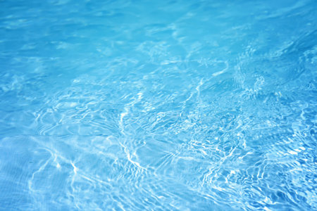 The surface of the water in the blue swimming pool.