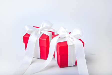 Two red gift boxes with white bows.の写真素材