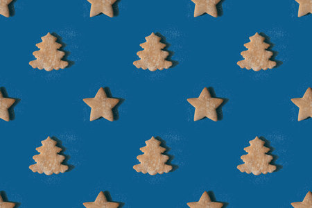 Pattern of gingerbread in the shape of stars and Christmas treesの写真素材