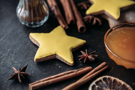 Christmas gingerbread in the shape of stars, spices and honey on a wooden table.の写真素材