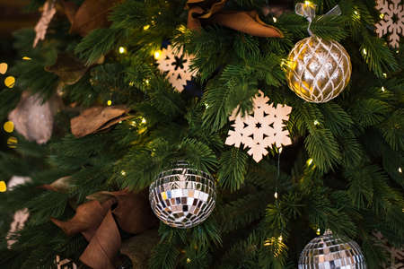 Christmas tree with with golden colored decorations. New year background.の写真素材