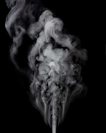 Puff of white smoke on black backgroundの写真素材