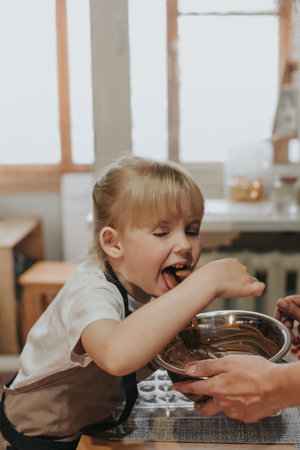 Mom and daughter make chocolate at home