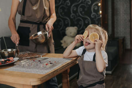 Mom and daughter make chocolate at homeの写真素材