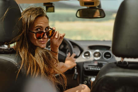 Summer portrait of a girl in the car.の写真素材