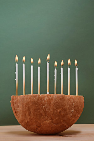 Creative Hanukkah menorah on a wooden table.の写真素材