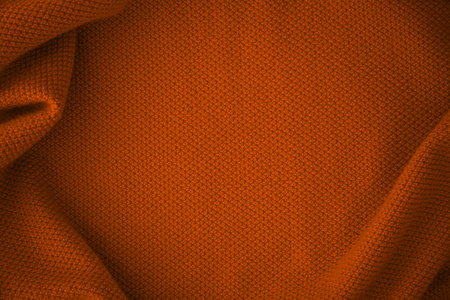 Texture of knitted fabric in trendy orange colorの写真素材